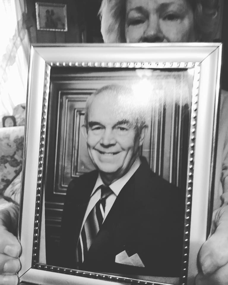 Fonda Wells holding a picture of her missing husband, Stanley